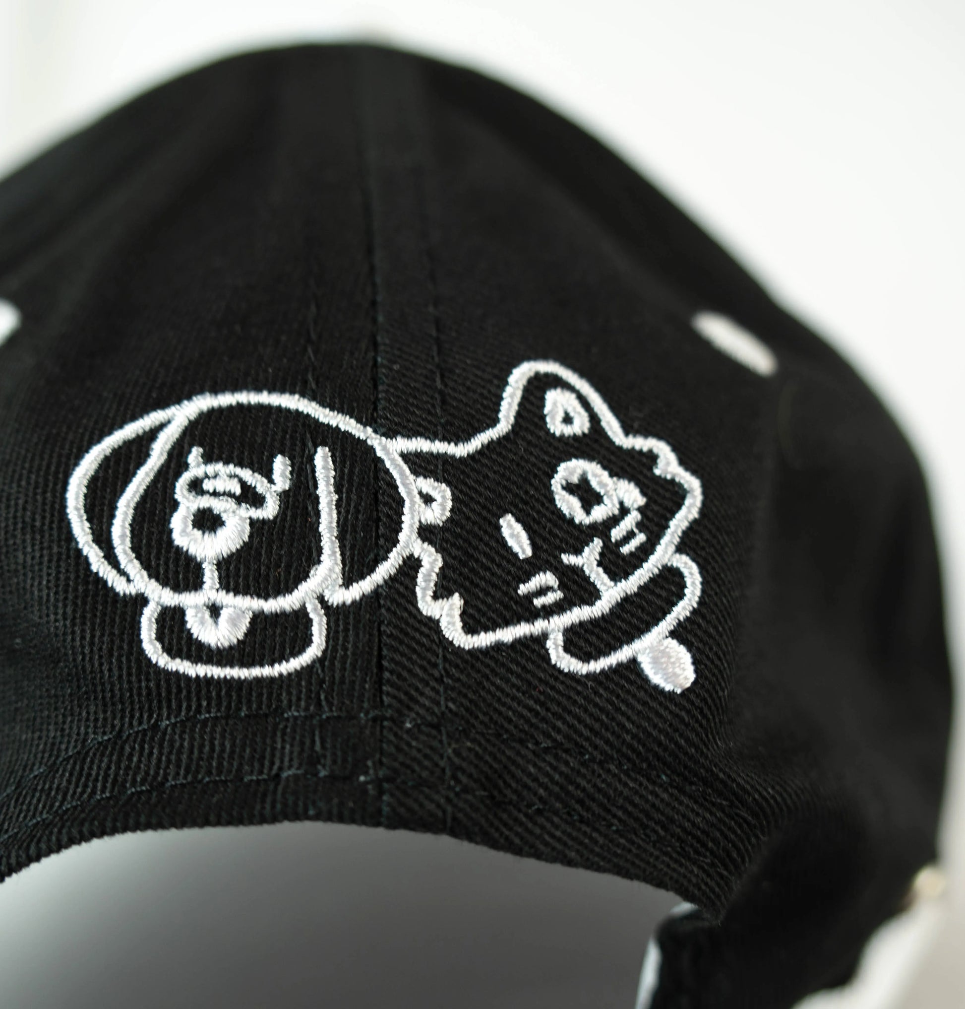 Back embroidery of dog and cat on an adjustable strapback cap—cute animal accessory for kawaii furry clothing lovers.