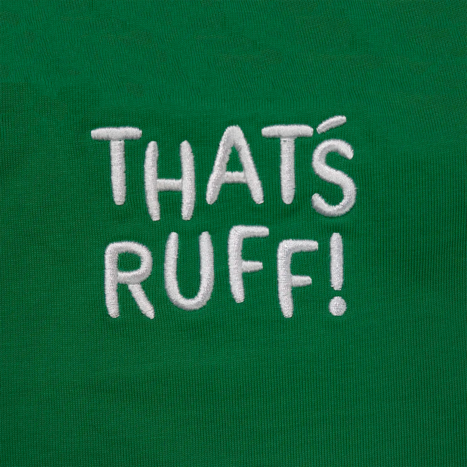 Close-up of the back-neck embroidery reading THAT'S RUFF on an emerald-green tee—kawaii streetwear, unisex graphic pocket shirt.