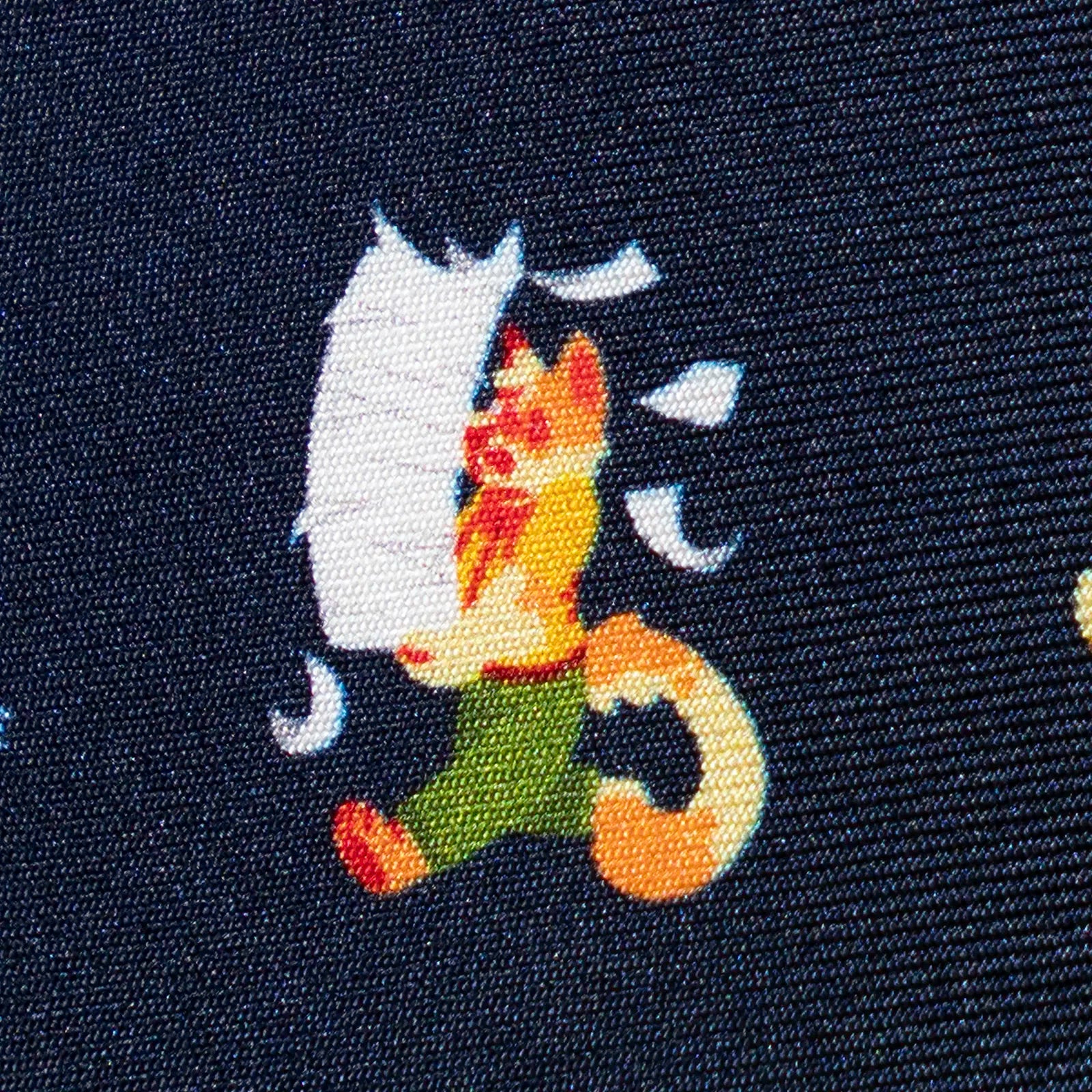printed design of a cartoon calico cat character on fabric.