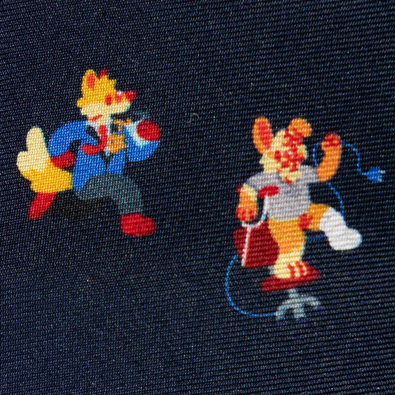 Two printed cartoon characters (a fox and a rabbit) on a dark silk fabric background.