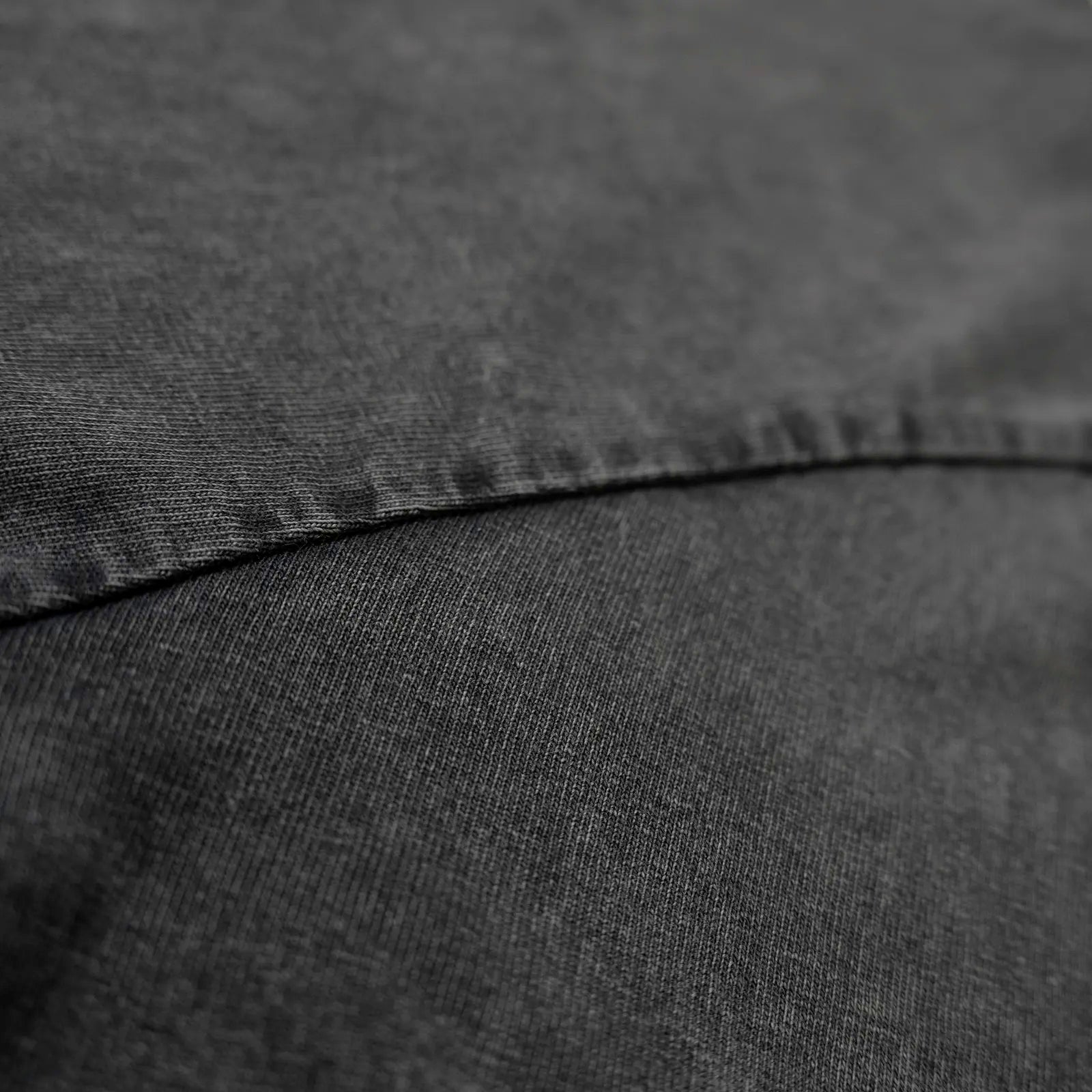 Fabric detail of acid-wash grey 260gsm heavyweight cotton from an oversized tee—durable streetwear.