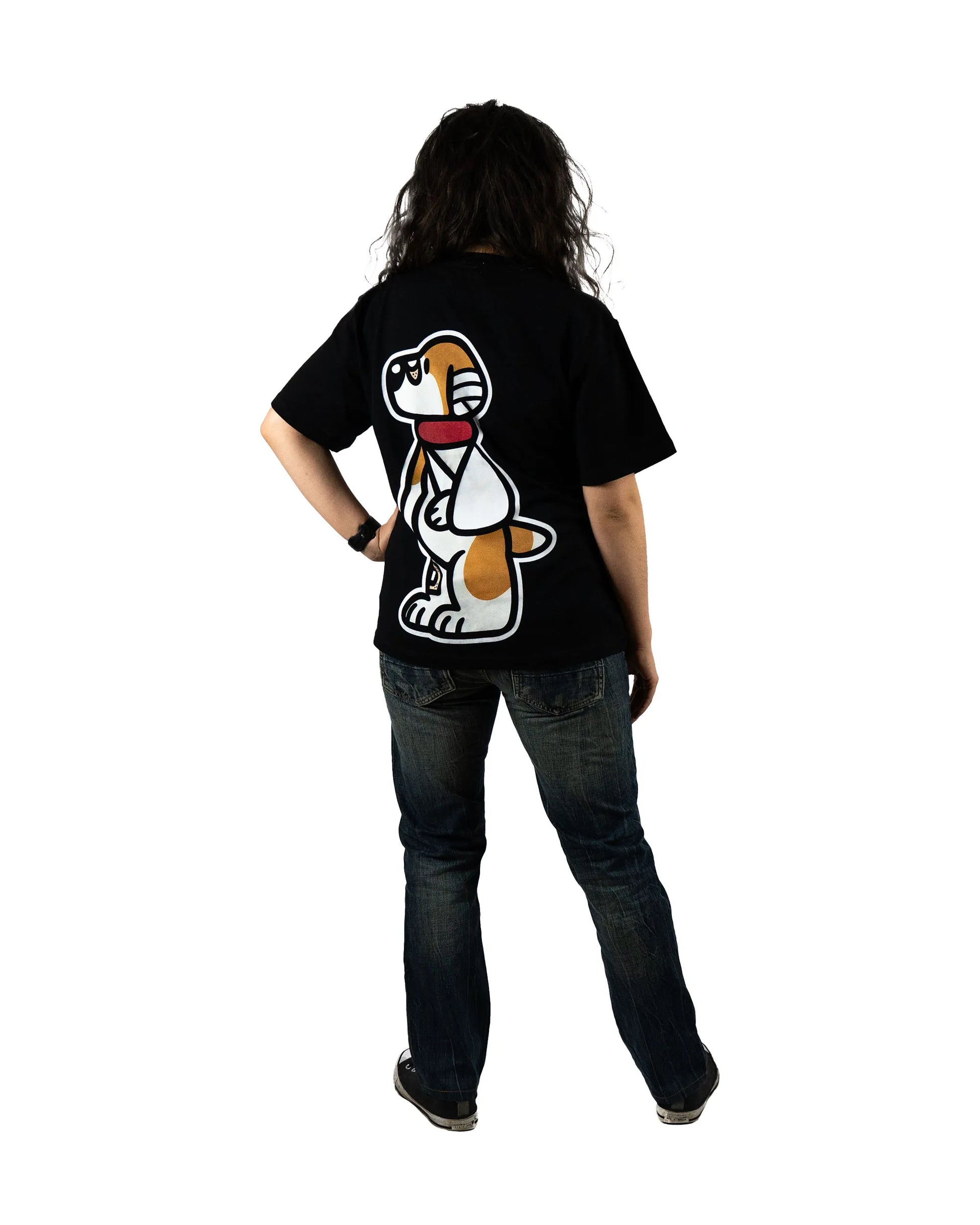 Back view of a model wearing a black t-shirt featuring a large dog graphic design from the 'That's Ruff!' collection. Paired with casual jeans and sneakers, this outfit blends playful design with everyday comfort.
