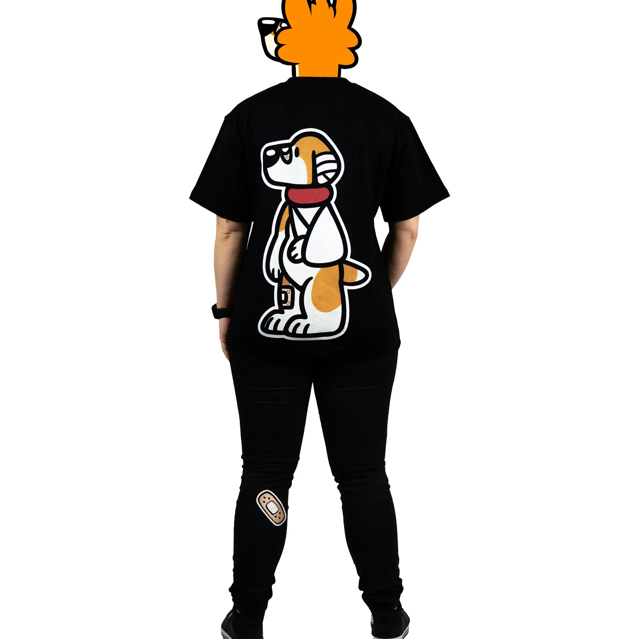 Back view of a model wearing a black furry fandom t-shirt featuring a bold and playful dog graphic from the 'That's Ruff!' collection. Paired with patched black pants and sneakers, this outfit showcases a fun and casual streetwear-inspired look.