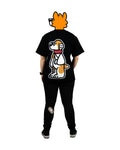 Back view of a model wearing a black furry fandom t-shirt featuring a bold and playful dog graphic from the 'That's Ruff!' collection. Paired with patched black pants and sneakers, this outfit showcases a fun and casual streetwear-inspired look.