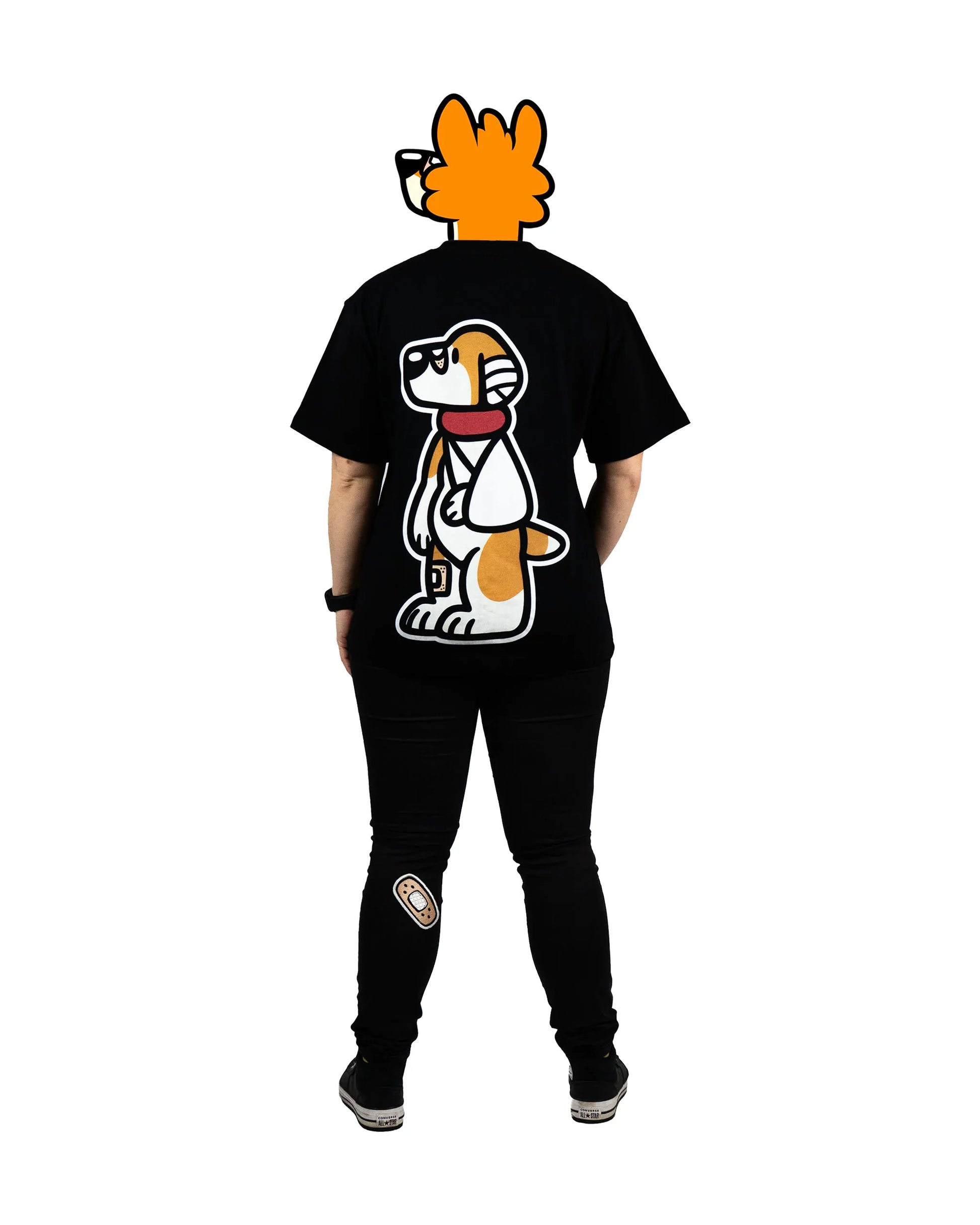 Back view of a model wearing a black furry fandom t-shirt featuring a bold and playful dog graphic from the 'That's Ruff!' collection. Paired with patched black pants and sneakers, this outfit showcases a fun and casual streetwear-inspired look.