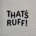 Detail of the THAT'S RUFF hem print on a beige tee—simple branding on a premium cotton basic.