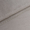 Zoomed fabric texture showing dense heavyweight cotton knit on a beige tee for everyday durability.
