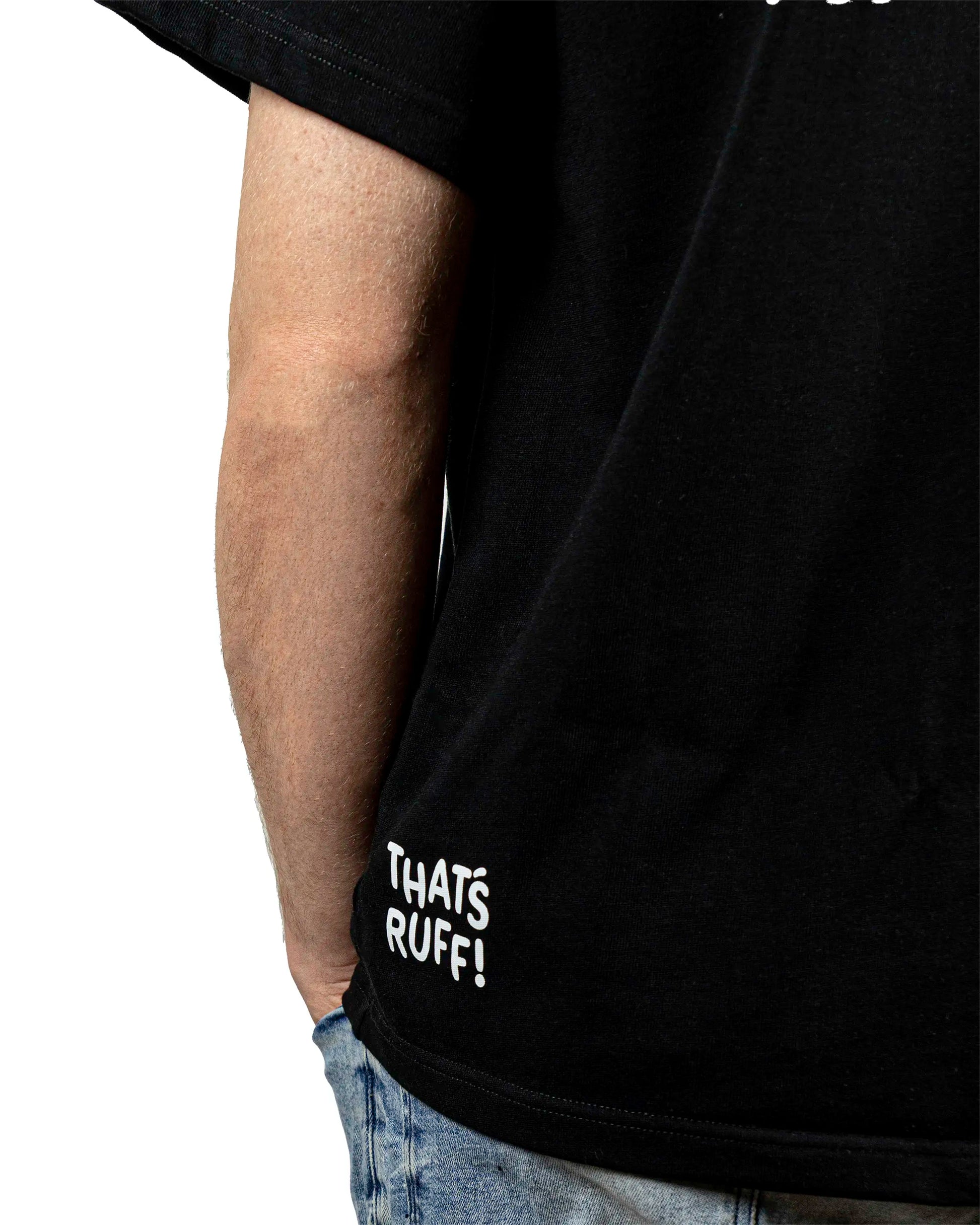 Close-up of a black t-shirt featuring the 'That's Ruff!' logo printed near the hem. A subtle yet stylish detail that adds character to this casual and versatile piece from the 'That's Ruff!' collection.