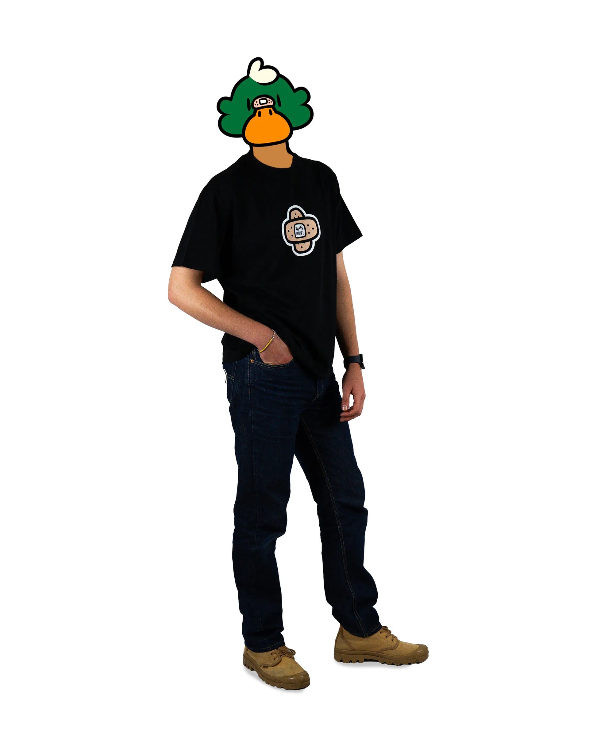 Full-body view of a duck model wearing a black t-shirt featuring a bold bandage logo design from the 'That's Ruff!' collection. Paired with dark jeans and tan boots, this outfit captures a clean and casual streetwear look.