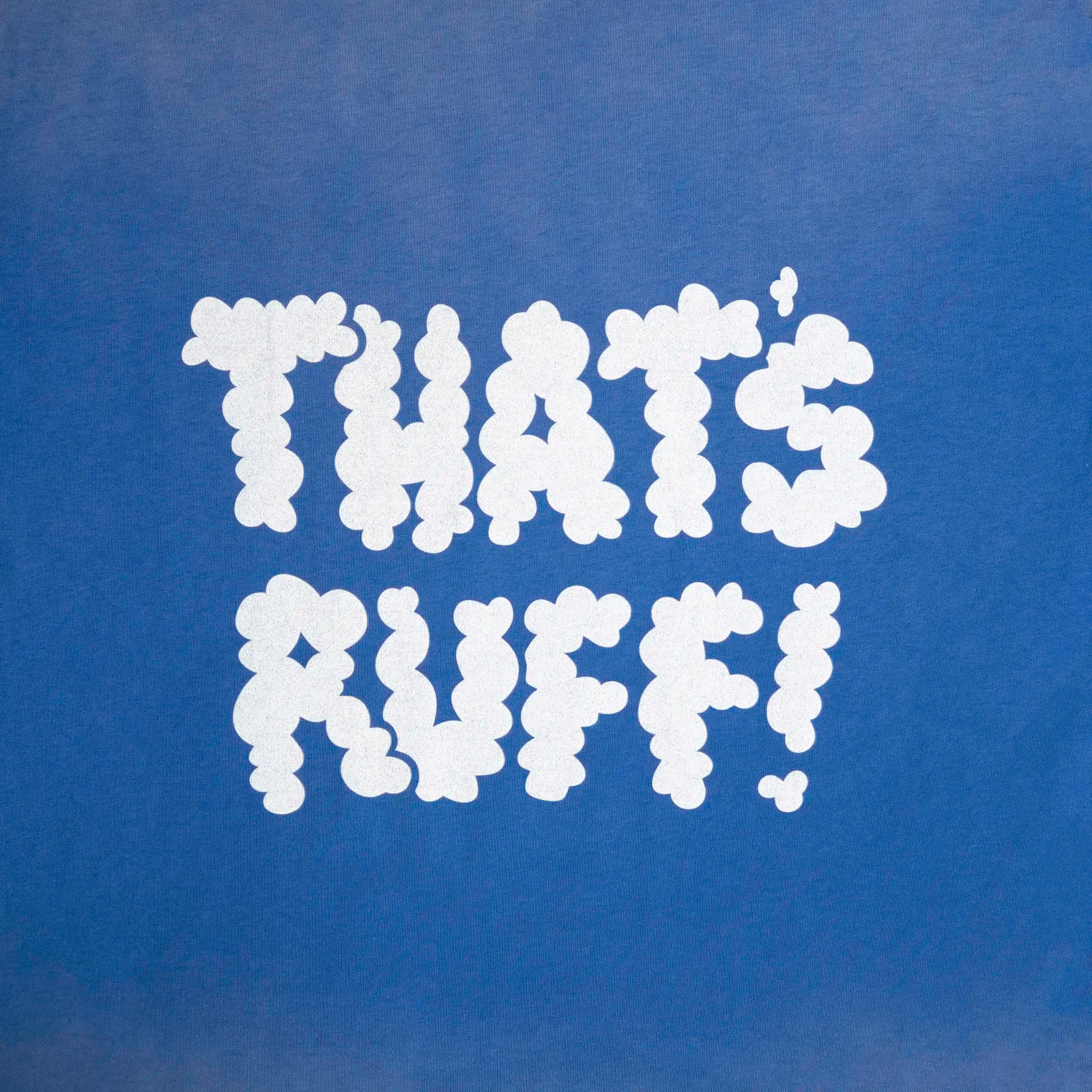 Back print close-up showing the THAT'S RUFF cloud logo on a blue oversized tee—furry clothing/furry merch.