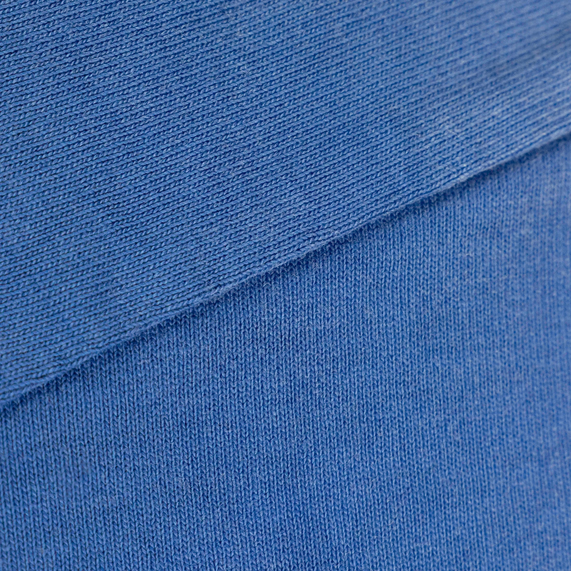 Blue 260gsm heavyweight cotton fabric detail with spray-dyed fade from an oversized tee—durable furry clothing.
