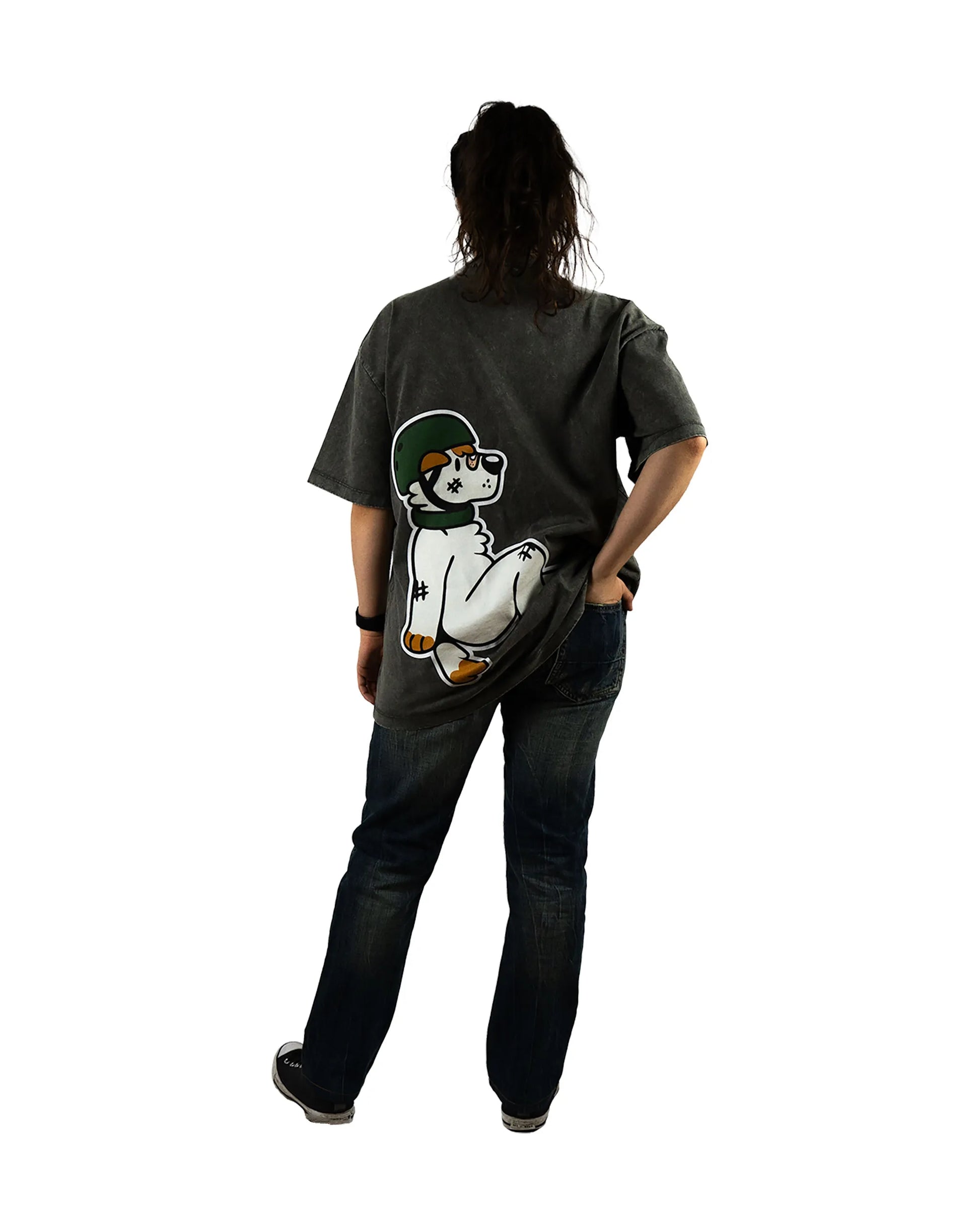 Back view of a model wearing the That's Ruff! gray t-shirt, a standout piece of furry clothing featuring a bold graphic of an anthropomorphic dog in a helmet. Paired with black pants adorned with That's Ruff! patches and a green helmet, this outfit captures the playful, rugged spirit of furry-inspired fashion.