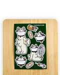 Green sticker sheet from the 'That's Ruff!' collection featuring a playful samoyed dog named Lamp wearing a cone of shame, bandages, and humorous medical-themed graphics. A fun and quirky design perfect for decorating laptops, journals, or water bottles with bold and creative flair.
