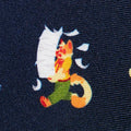 printed design of a cartoon calico cat character on fabric.
