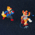 Two printed cartoon characters (a fox and a rabbit) on a dark silk fabric background.