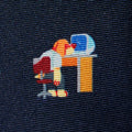Embroidered design on fabric showing a beagle character looking at a crashed computer at a desk.