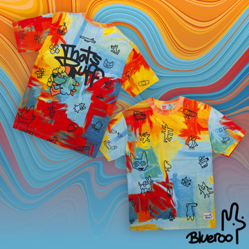 T-shirt covered in animal prints with a THAT'S RUFF logo and a drawing of palette the artist Spaniel on multicolour screen printed fabric.