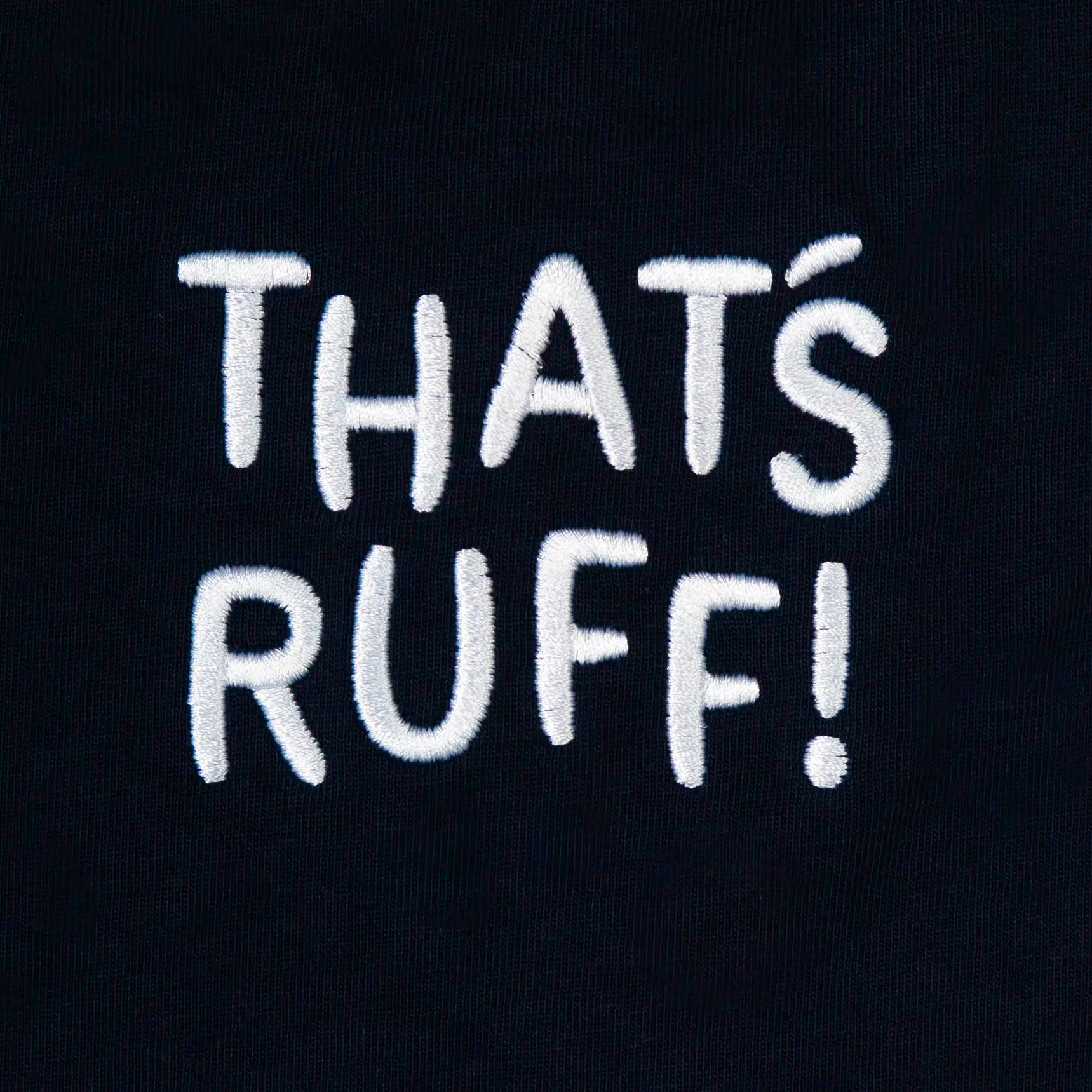 Close-up of THAT'S RUFF back-neck embroidery on dark navy pocket tee—kawaii streetwear for animal lovers
