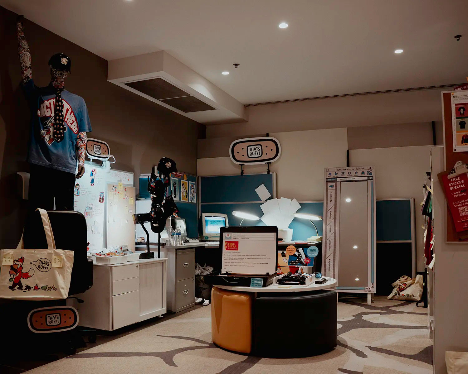 THAT’S RUFF pop-up in Sydney with an office-themed setup—mannequin, desks and computers showcasing tees, hats, pins and sticker sheets.