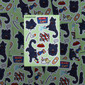 Spread of Vandal black cat sticker sheets; sustainable plant-based decals for journals, skate gear, and cases.